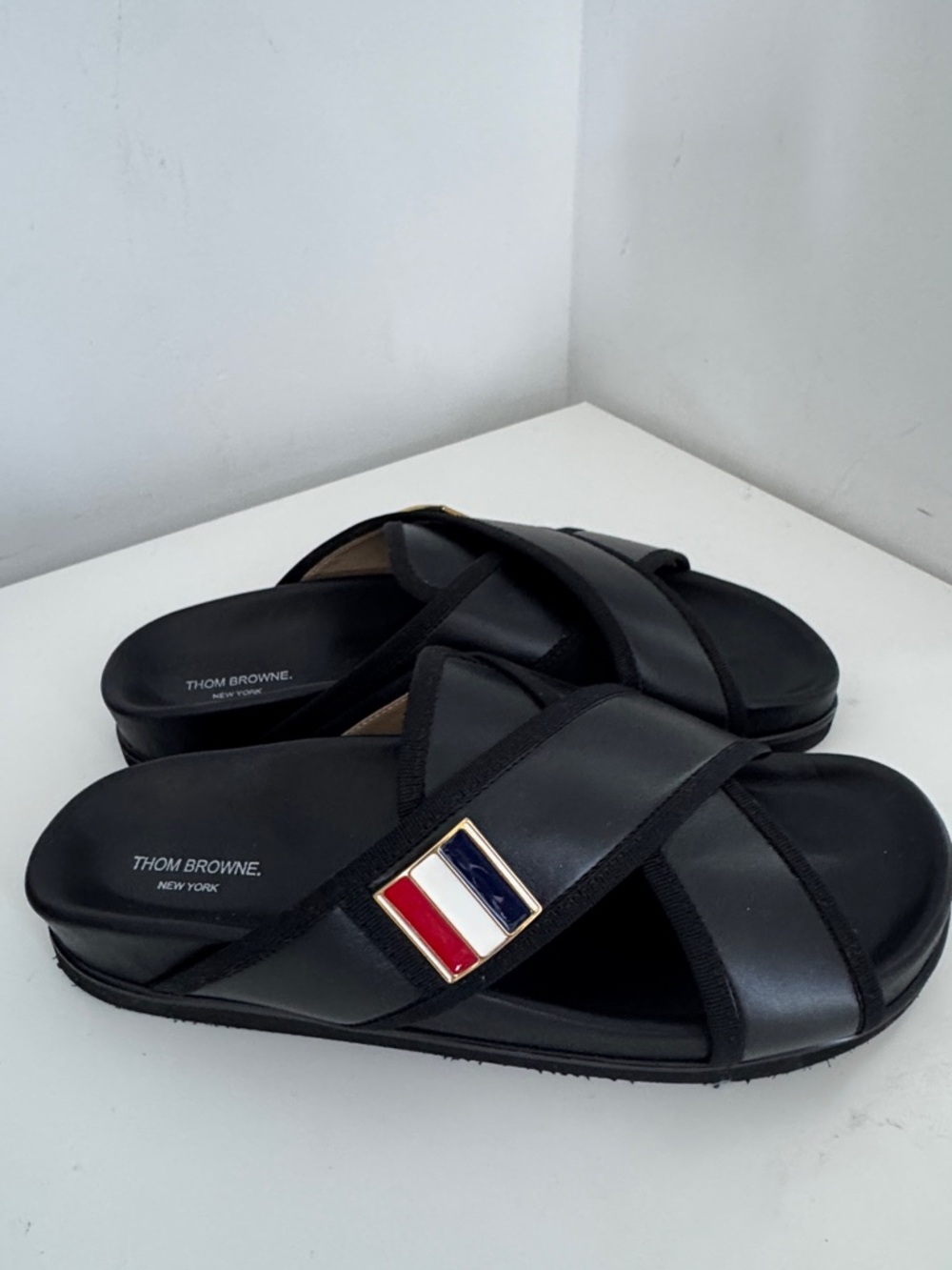 Thom Browne Black Leather Crisscross Slides with Tricolor Accents.